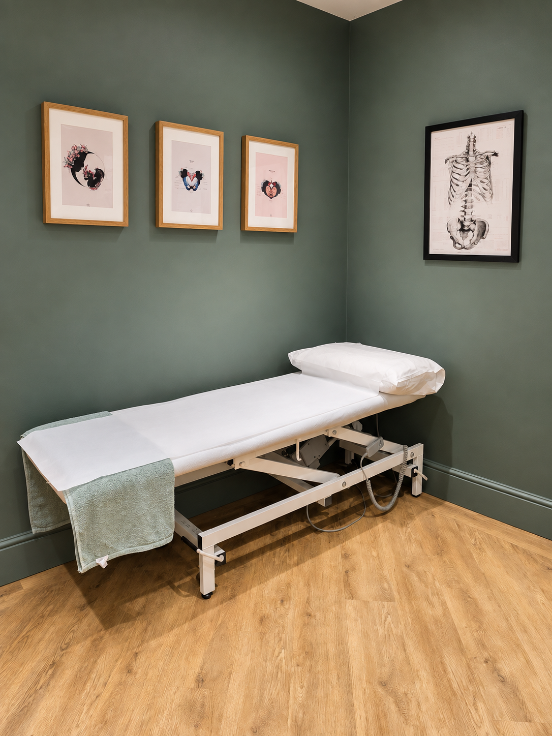 Treatment couch and framed artwork in the private physiotherapy clinic